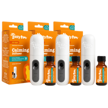 Zesty Paws calming diffuser starter kit with three white diffusers, three amber bottles, and orange packaging boxes.